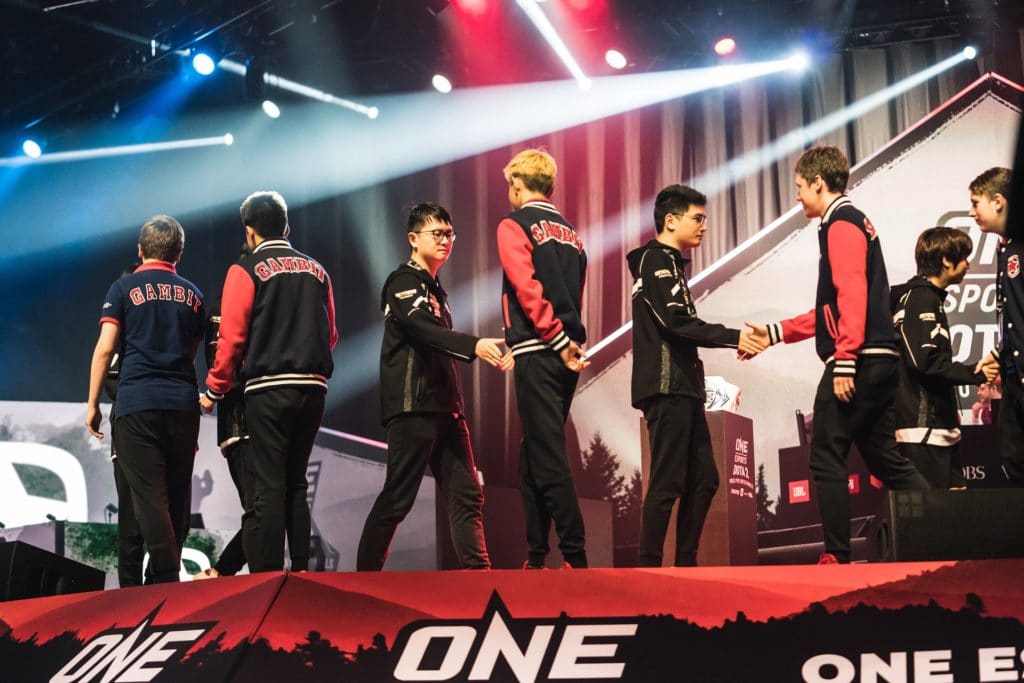 Gambit shake hands with Vici on stage after their loss