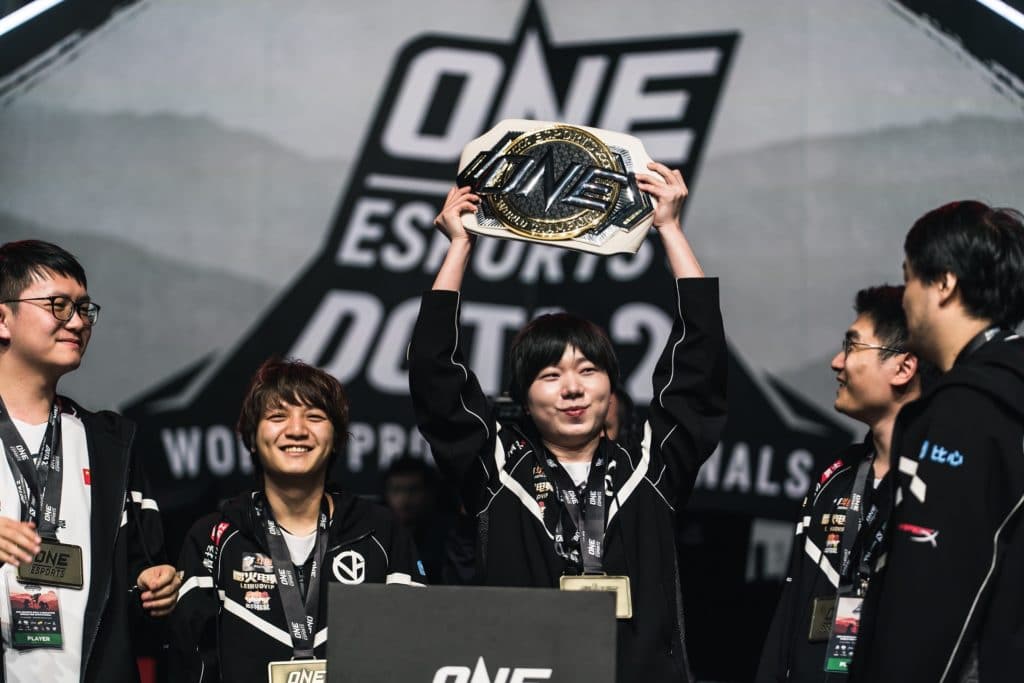 Eurus holds up the trophy on stage after winning the ONE Esports Dota 2 World Pro Invitational