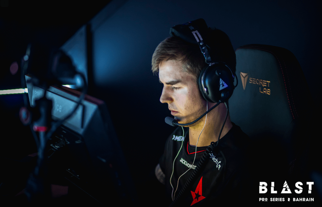 Device with head set on sitting at his monitor ready to play.