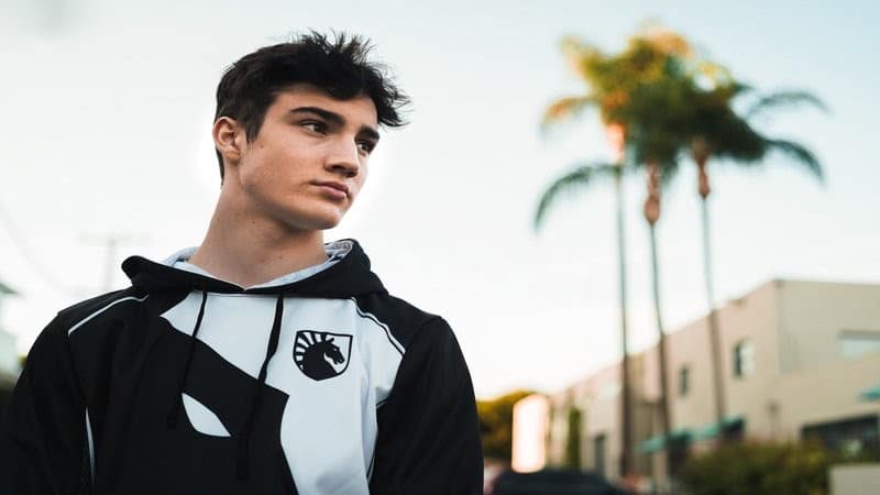 Liquid's Cented stands with his Team Liquid hoodie in front of palm trees