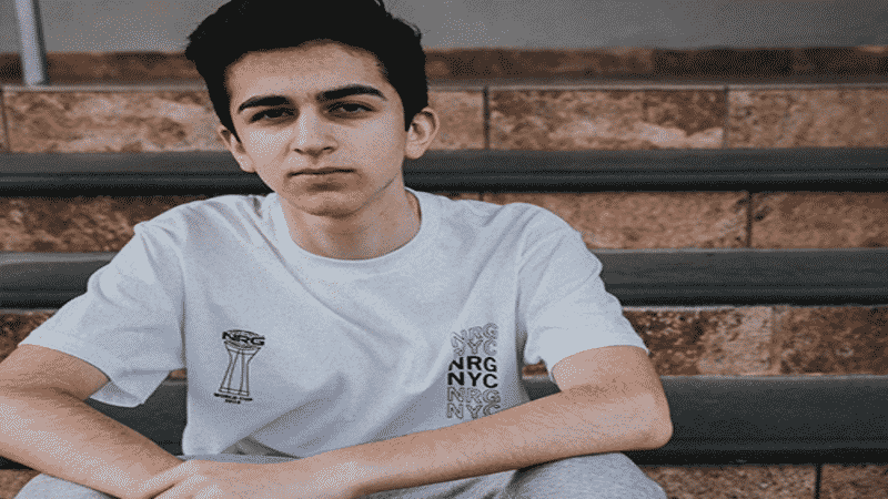 NRG's EpikWhale sits in a white NRG branded T-shirt 