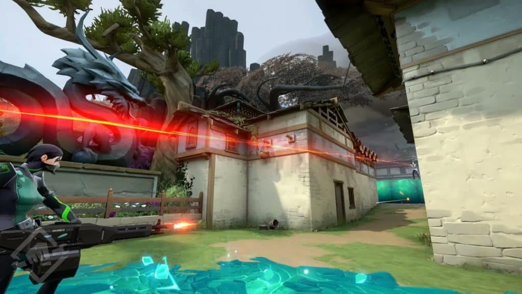 An in game shot of the character Sage, with a gun, firing in the direction of a red sniper's laser pointed just above her head