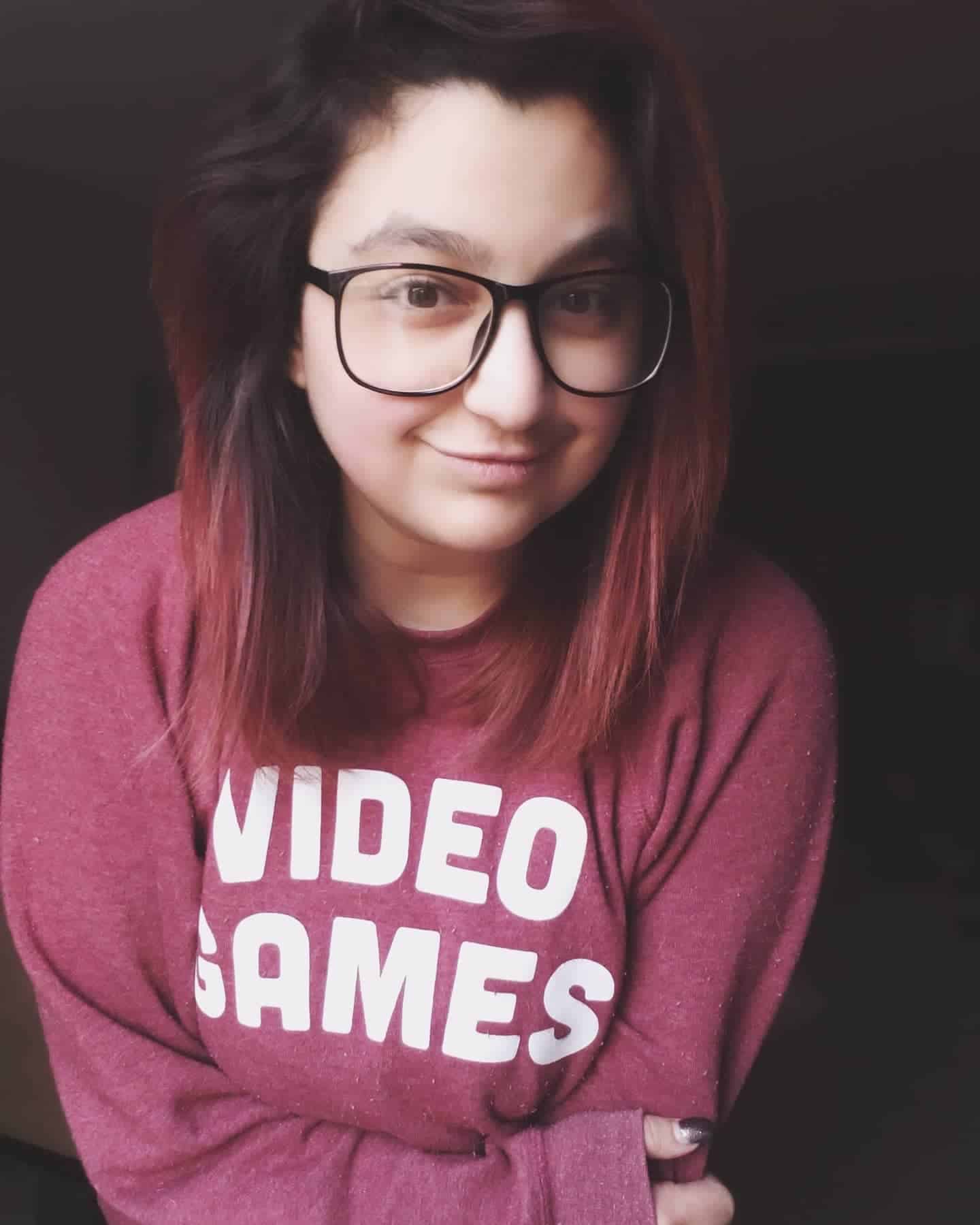 Jambo smiles for the camera wearing a dark red hoodie with the words "video games" in bold white letters on the front