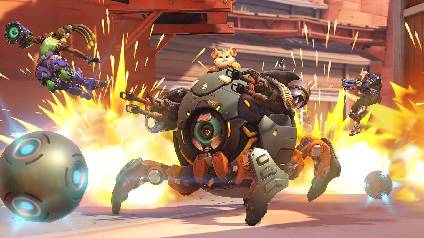 Wrecking Ball rolls into action in his mech, its gatling guns drawn and ready. Sparks explode behind him.