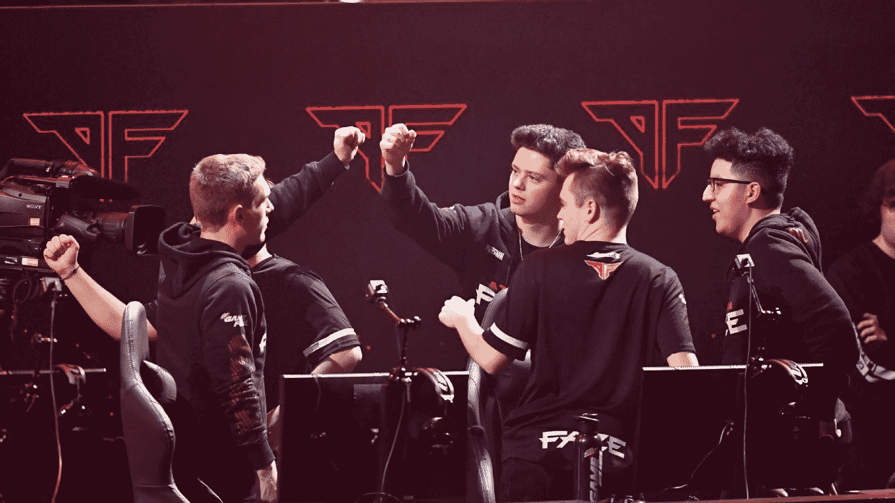 The members of the Atlanta Faze bump fists above their monitors after a win