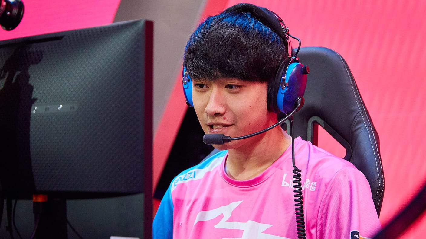 Bazzi sits behind the monitor with his team jersey and headset on