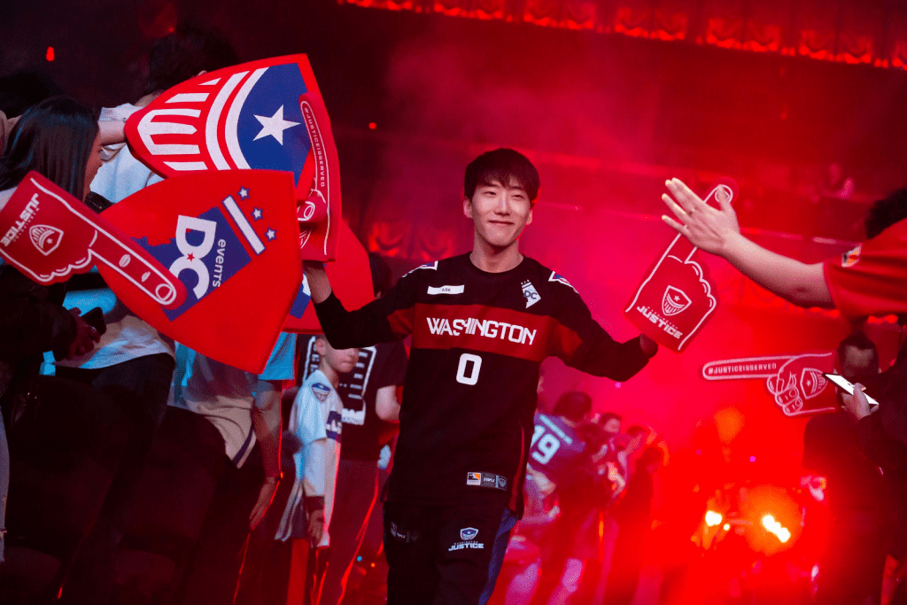 Washington Justice Overwatch league player high fiving fans in a crowd