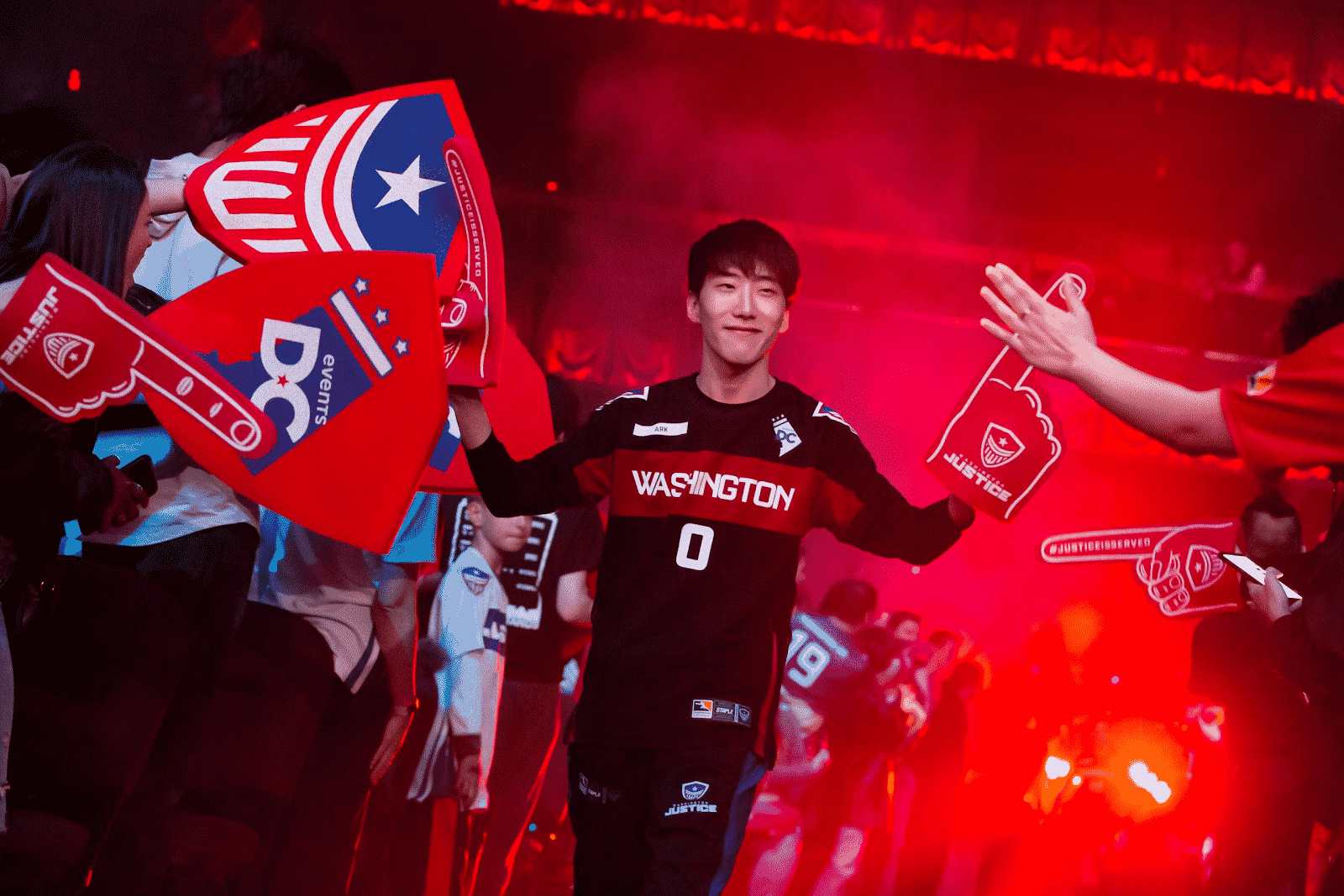 Washington Justice Overwatch league player high fiving fans in a crowd