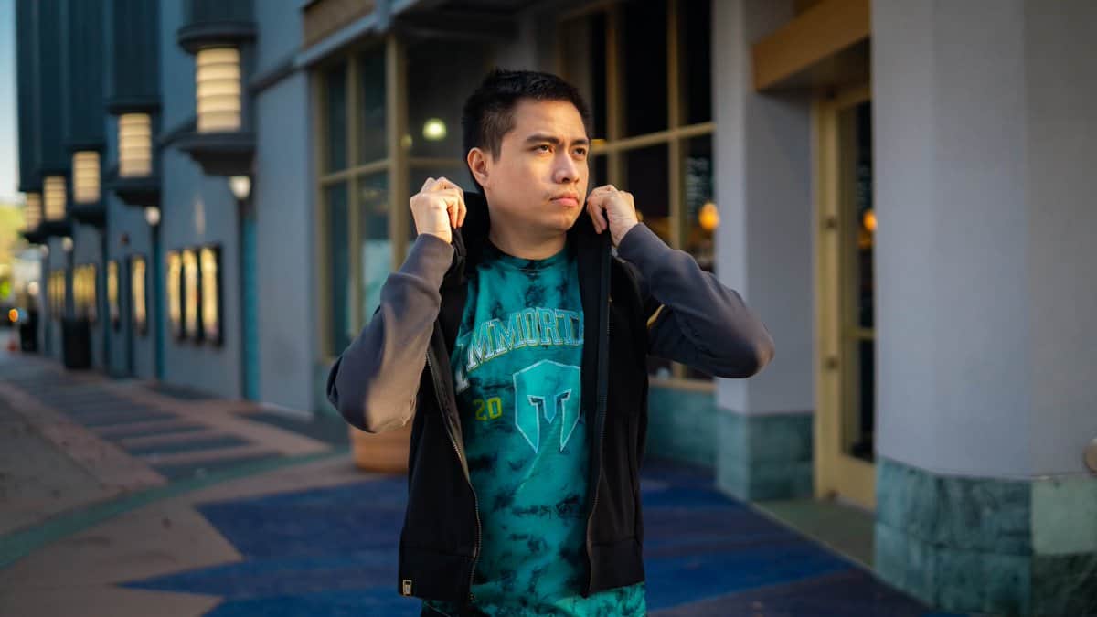 LCS player Xmithie flipping up his hood with an Immortals jersey underneath his jacket