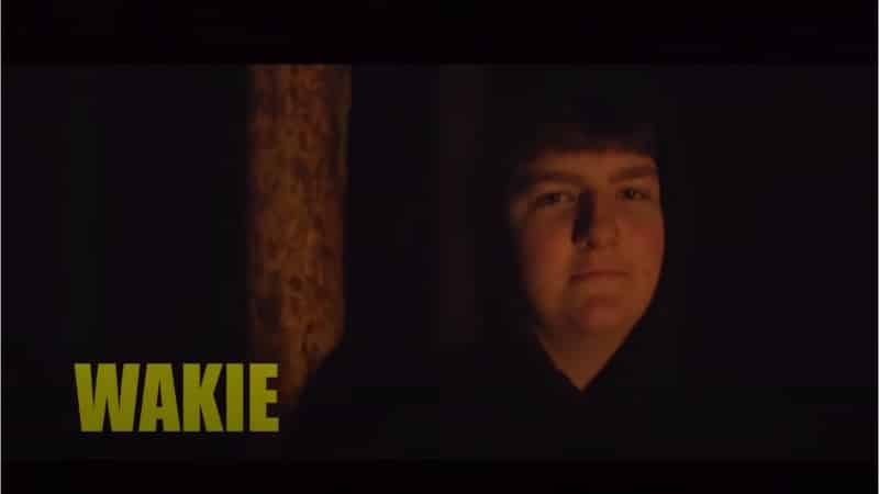 Pro Fortnite player Wakie with a black hoodie on in a dark room