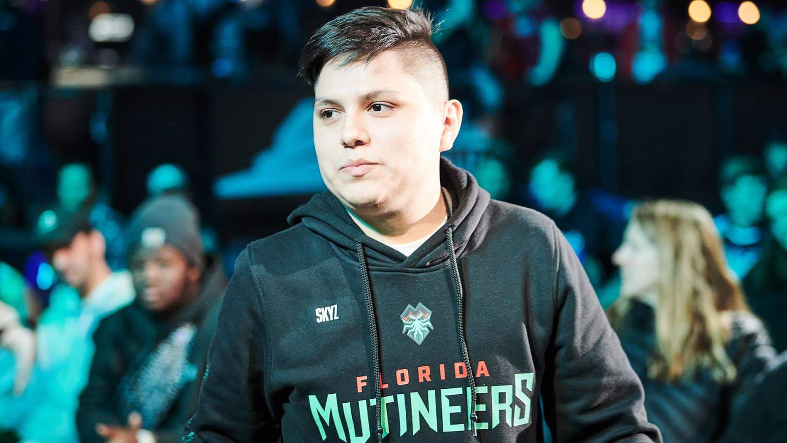 Cesar “Skyz” Bueno walks on stage, smiling, wearing his Florida Mutineers hoodie