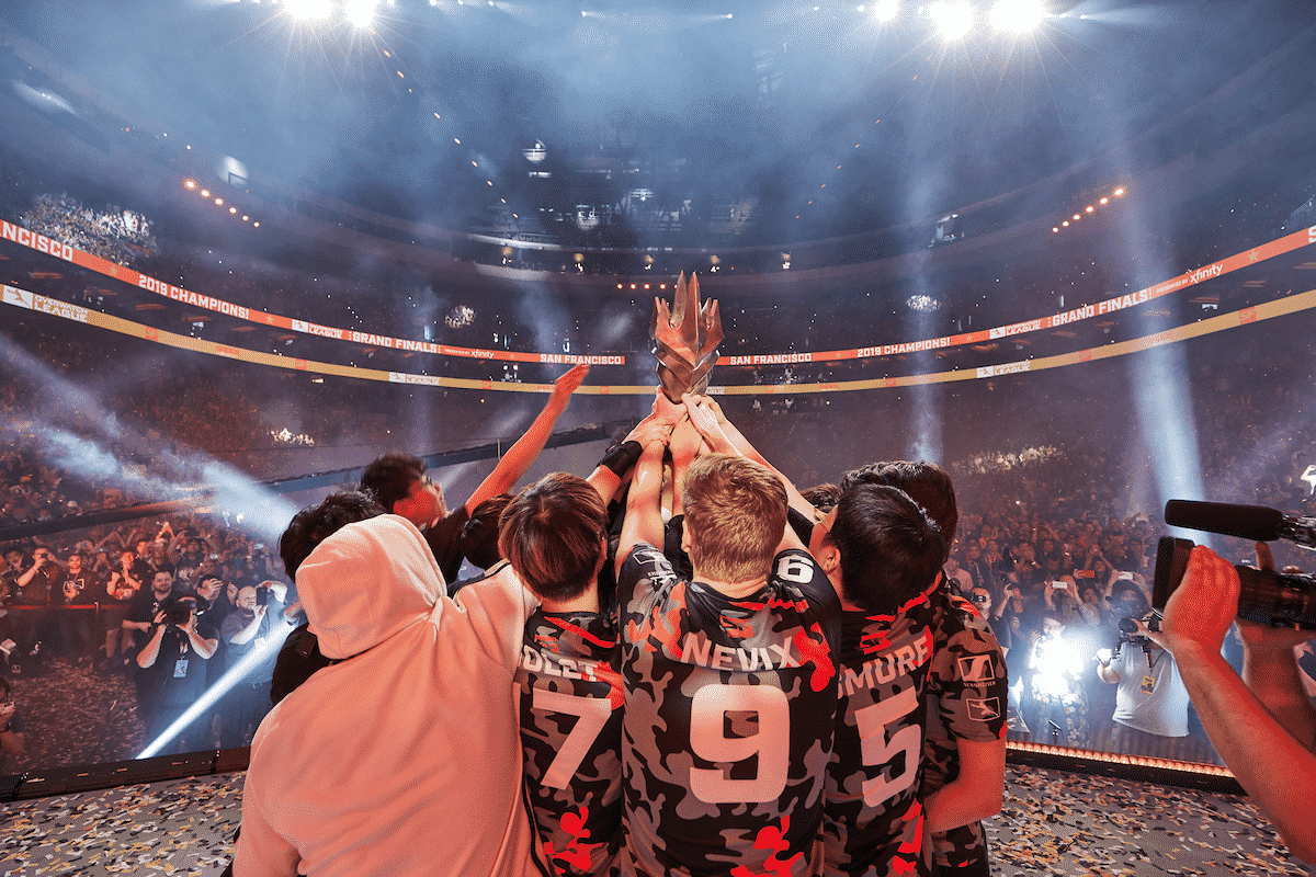 The Sanfrancisco Shock huddle around the trophy after being crowned champions in 2019