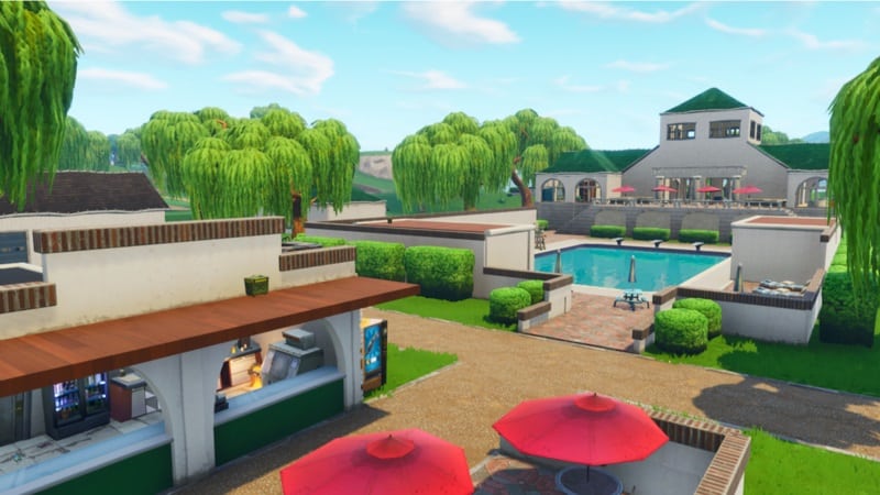 A picture of Lazy Links, an area in Fortnite, which has a diner with a mansion and a large pool