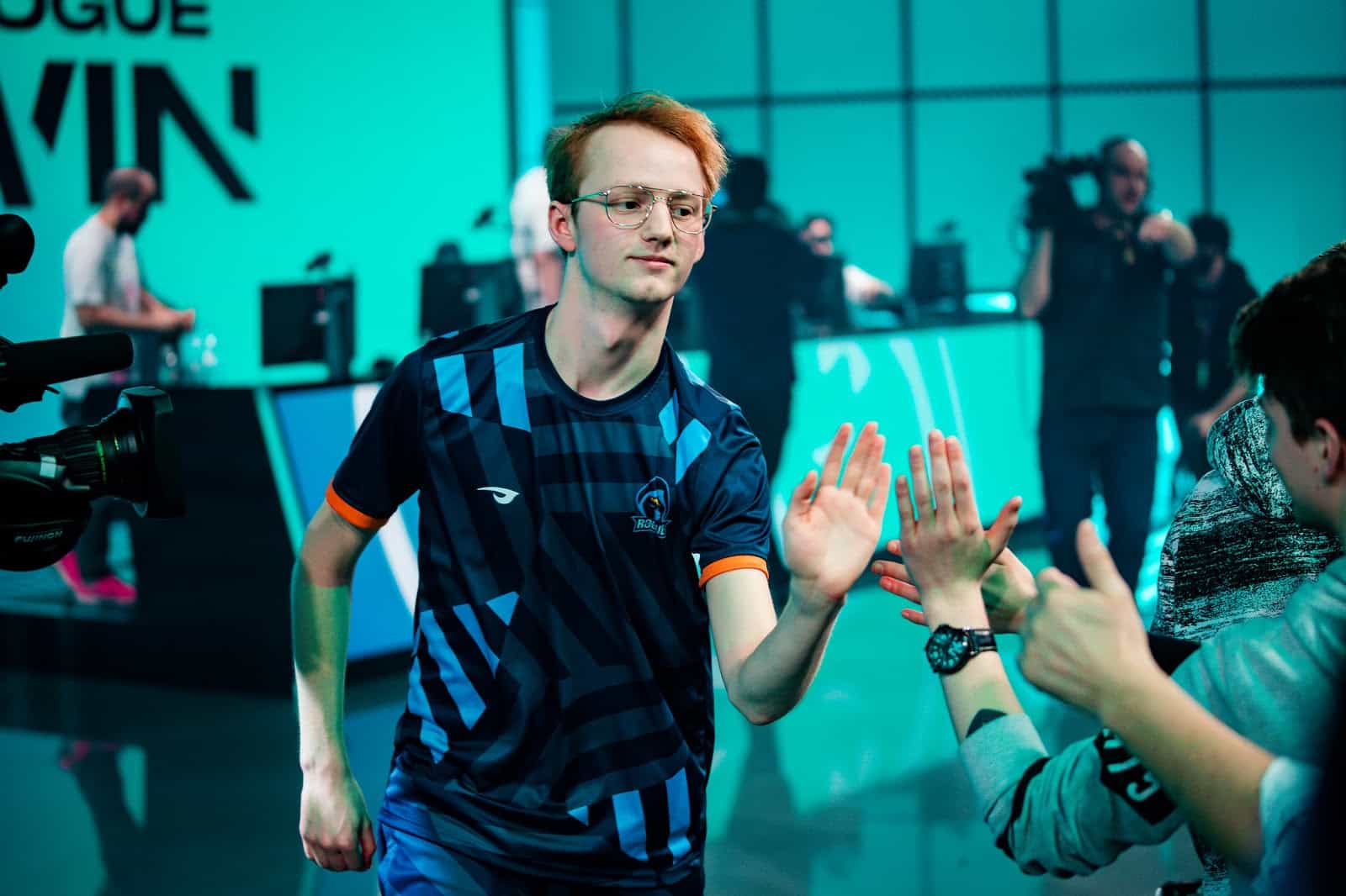Rogue LEC player Larssen high fiving fans after a win