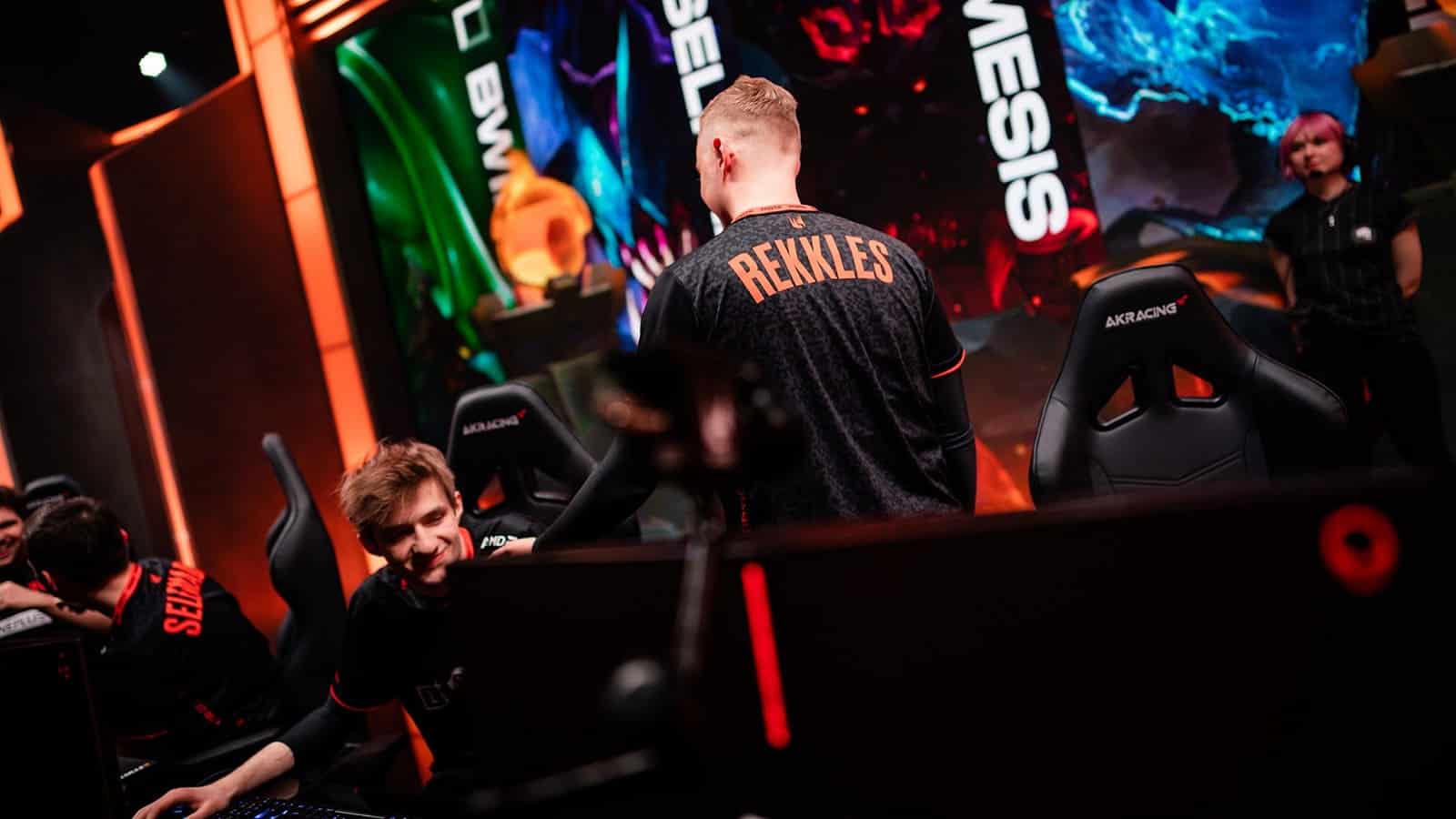 Fnatic's Rekkles walks away from the camera and pats teammate Nemesis on the shoulder after an LEC win