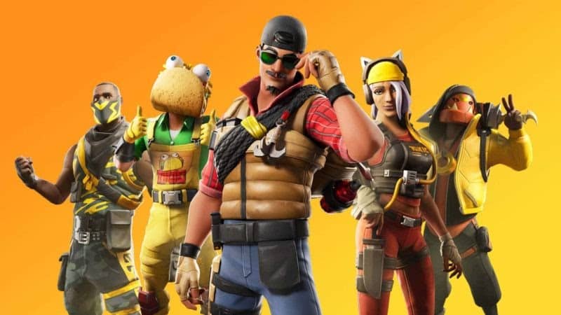 Five characters dressed up in Fortnite skins stand together in front of a yellow background