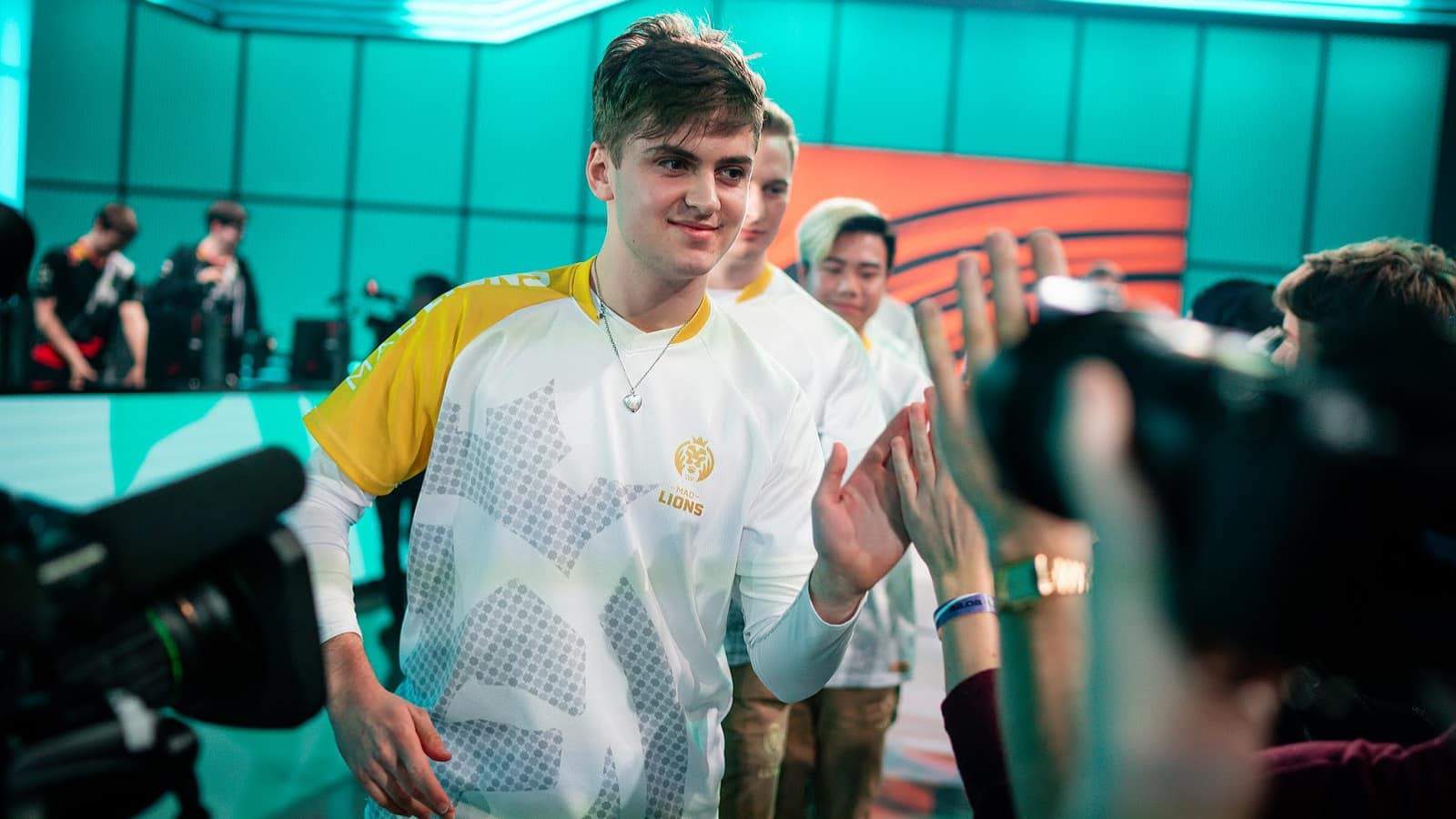 MAD Lions LoL ADC player Matyáš "Carzzy" Orság high fives fans in the LEC arena after a victory