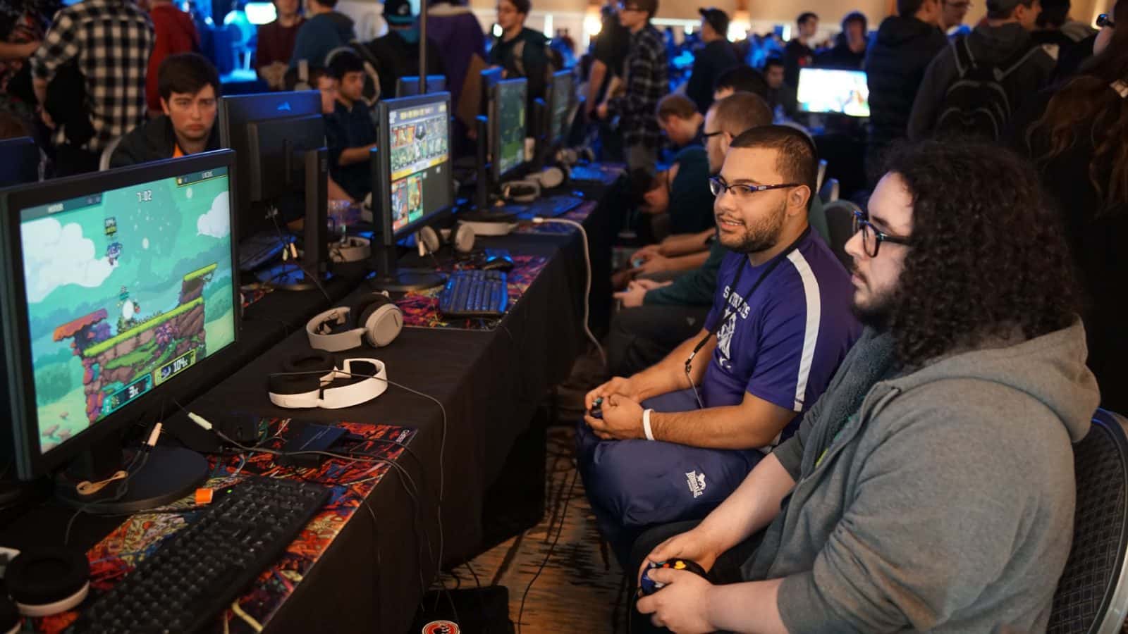 Gamers gather around their PCs during a LAN event