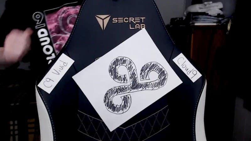 Vivid's gaming chair, with a hand drawn Cloud9 logo taped on and covering the Team Liquid logo