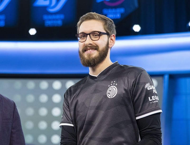 Bjergsen smiles for the camera on stage in his TSM jersey