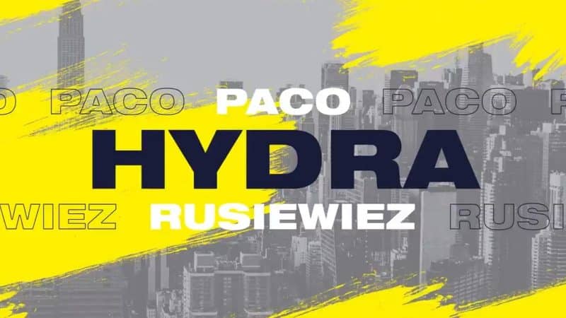The name Paco "Hydra" Rusiwiez appears on a greyed out picture of NY City with yellow paint strokes