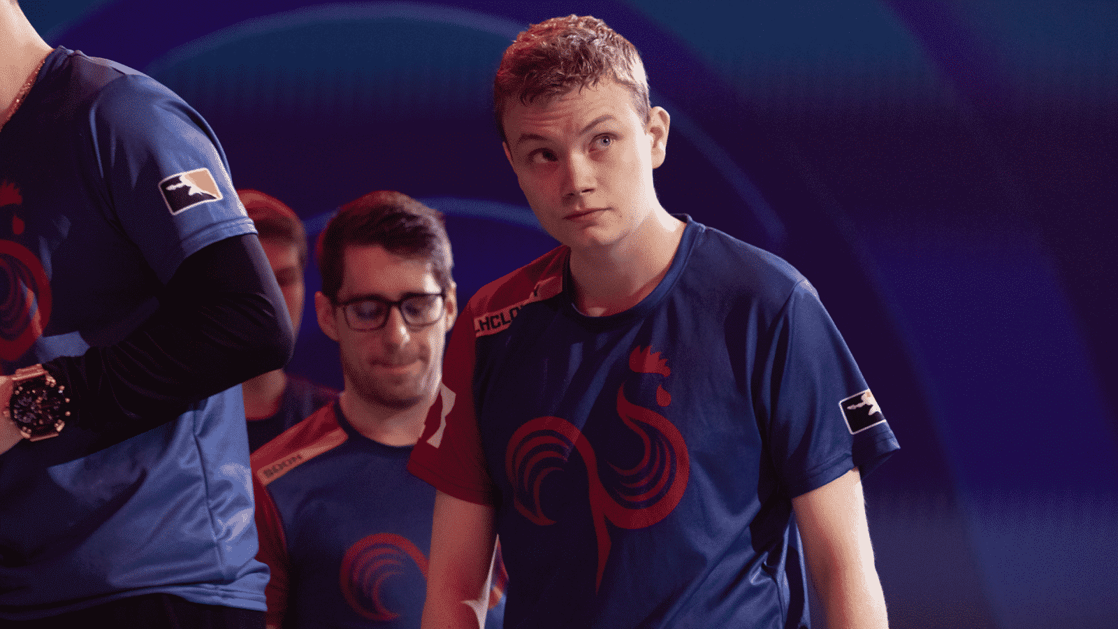 Overwatch League player Roni "LhCloudy" Tiihonen walks with his teammates and looks up to the side