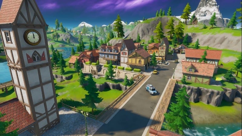 The in-game location, Misty Meadows, featuring red-roofed houses and an old-fashioned clock tower