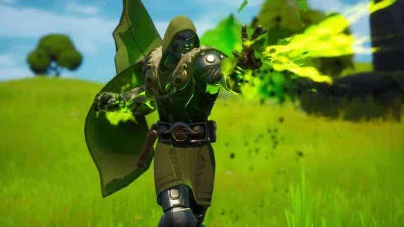 A Fortnite character with the Dr. Doom skin on shoots green energy from his hand in the middle of a sunny field