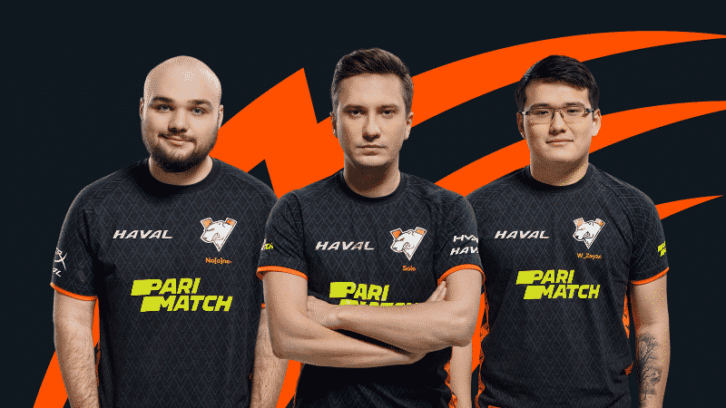 Alexey “Solo” Berezin, Vladimir “No[o]ne-“ Minenko and Bakyt “W_Zayac” Emilzhanov stand in their Virus.pro jerseys against a black and orange background
