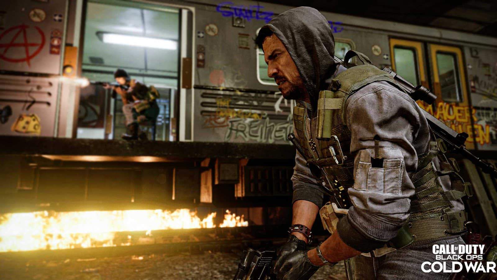 One female soldier shoots a rifle out of a graffiti-covered subway train with another soldier preparing his weapon to fire and the words "Call of Duty Black Ops Cold War" in the bottom left corner