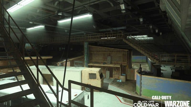 A picture of an arena with a bus and makeshift buildings for the new Verdansk Gulag in Call of Duty Black Ops Cold War