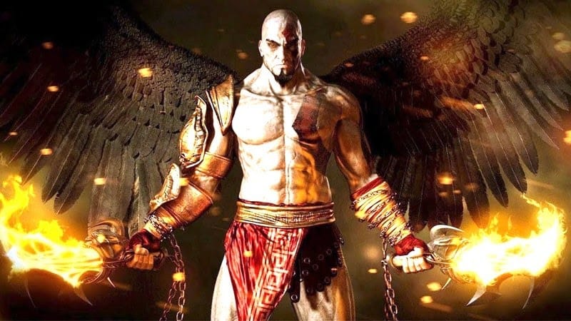 Kratos from the God of War series stands with two flaming short swords and black angel wings