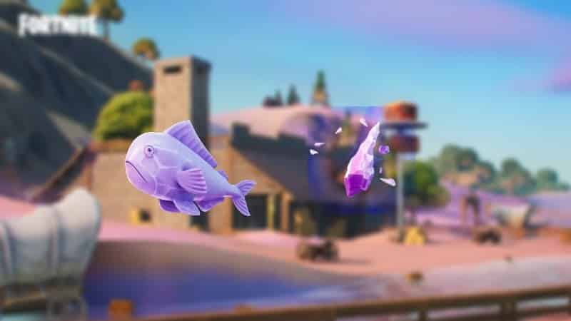 A purple Zero Point Fish and a purple crystal shard appear over a beach location in Fortnite