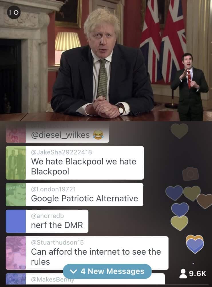 A phone screenshot, Boris Johnson appears in a livestream video delivering his Covid-19 address. Live messages being sent by viewers including "Nerf the DMR" can be seen below.