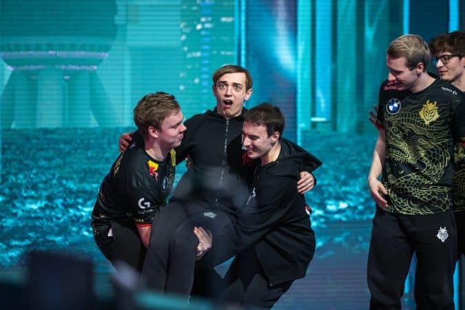 The roster of G2 Esports celebrates on stage after a win