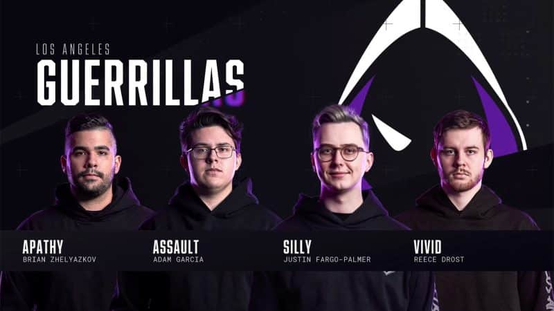 The roster of the Los Angeles Guerrillas stand facing the camera, their team logo, a hooded figure with glowing white eyes, appears behind them