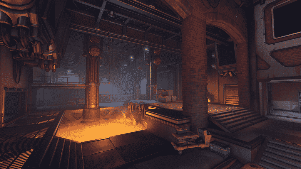 An industrial workshop area from a new Overwatch map is shown. In it, large pillars support the roof with pipes stretching across them and a large vat of molten lava stands in the middle of the vast room