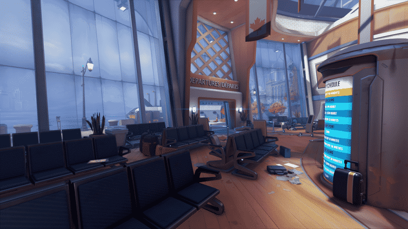 The inside of a station is shown from a screenshot of a new map in Overwatch. Empty chairs are lined up with a departure screen flashing in front and an open door leading outside with a Canadian flag above it.