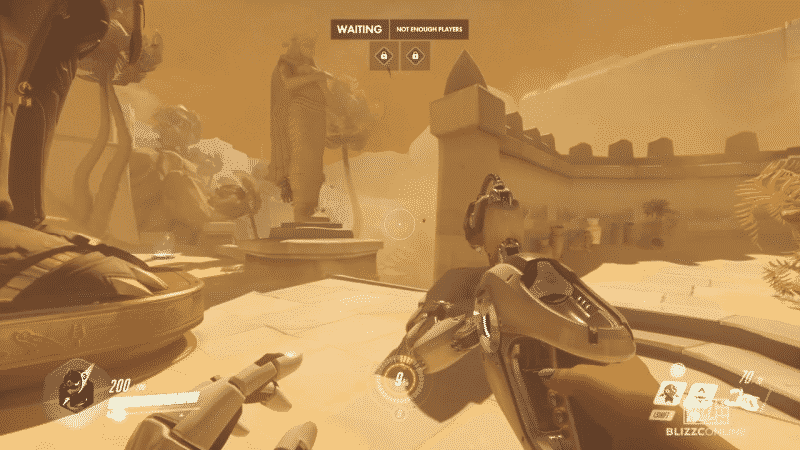 A first-person view of a player playing Overwatch on a desert city map with a heavy sandstorm brewing and complicating vision