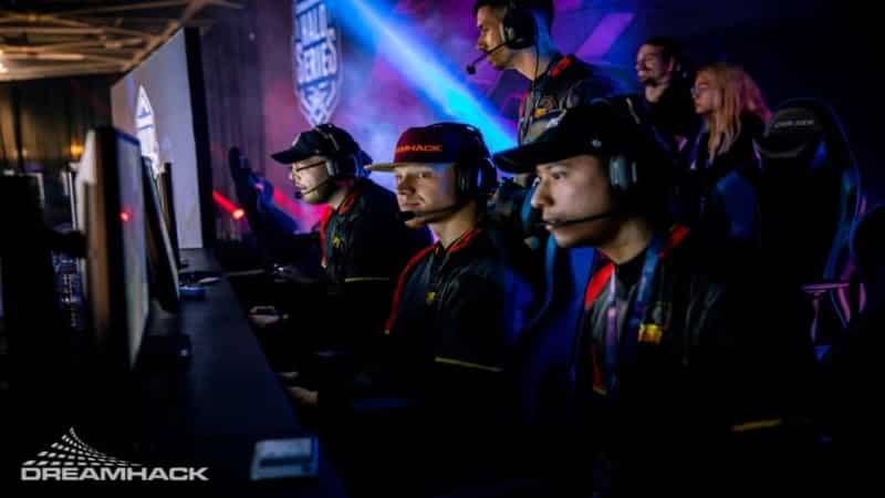 The RBG Esports CS:GO team sits on stage together with some people behind them and the DreamHack logo in the corner