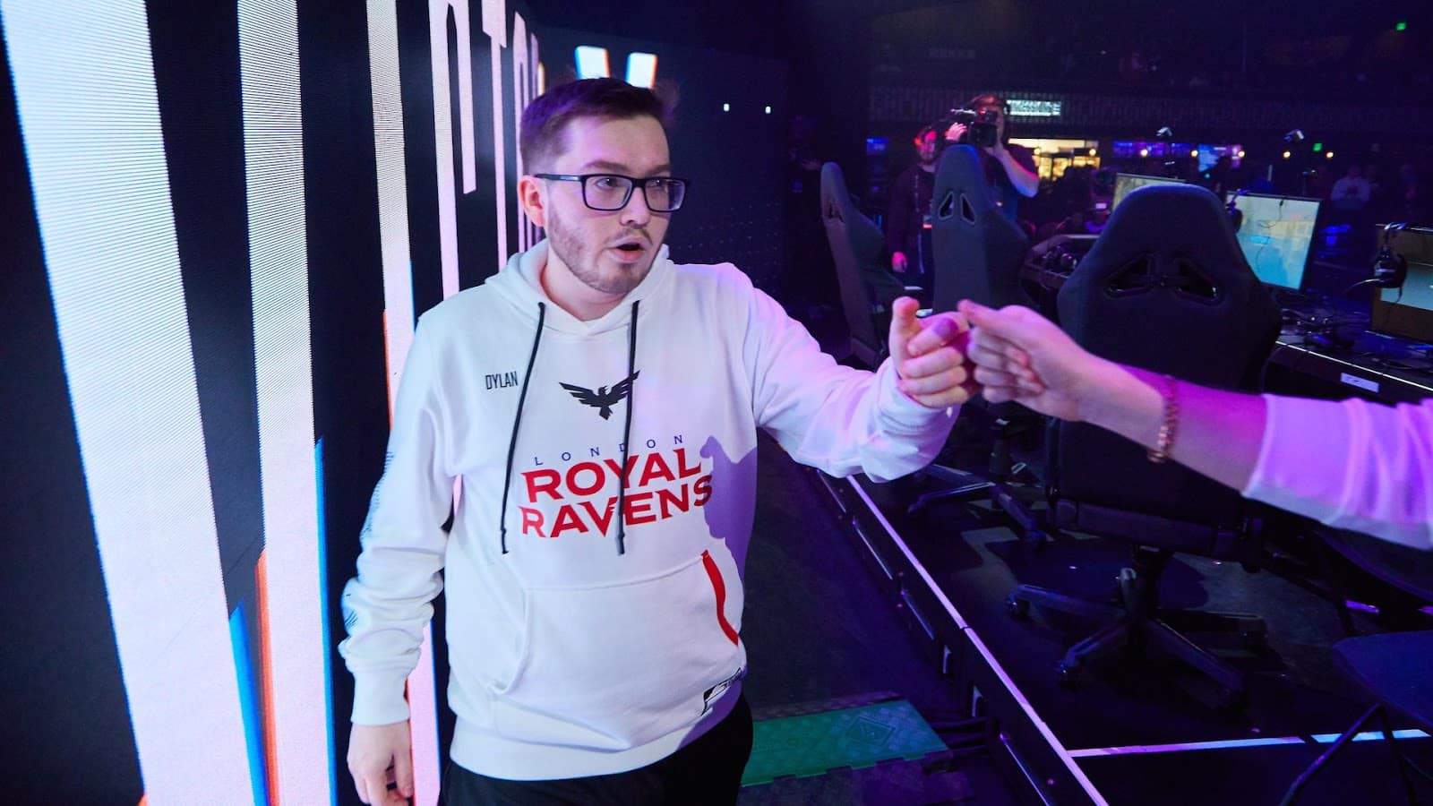 Thomas "Dylan" Henderson fist bumps a fan as he exits the stage after playing a match with the London Royal Ravens
