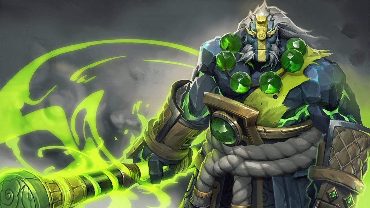 The Dota 2 hero Earth Spirit, a hulking behemoth rock-skinned humanoid, menacingly stands with a staff glowing green with power.