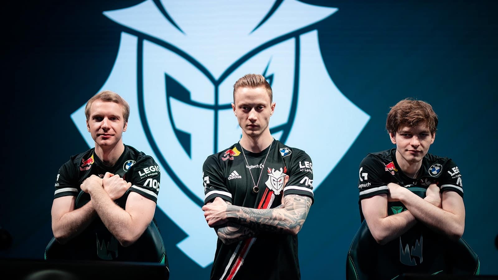 Pro LoL players for G2 Esports Jankos, Rekkles and Mikyx pose together with a G2 samurai logo behind them.