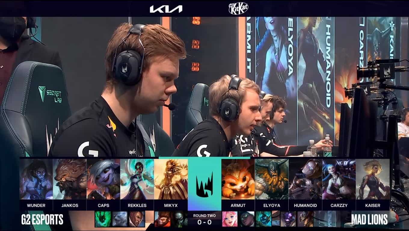 A screenshot from the LEC broadcast for Game One of the playoffs match between G2 Esports and MAD Lions. The picked and banned champion drafts appear at the bottom of the image with a shot of Wunder and the G2 lineup on stage above.