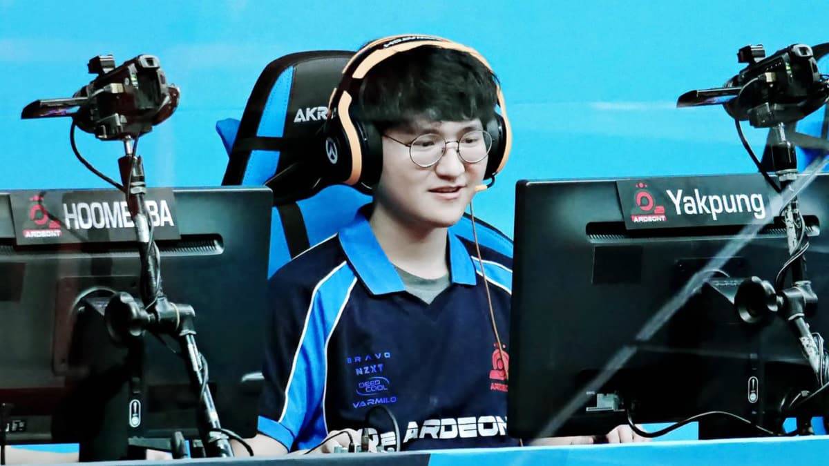 Overwatch player Dong-wook "BiaNcA" Kim grins at a PC on a stage.