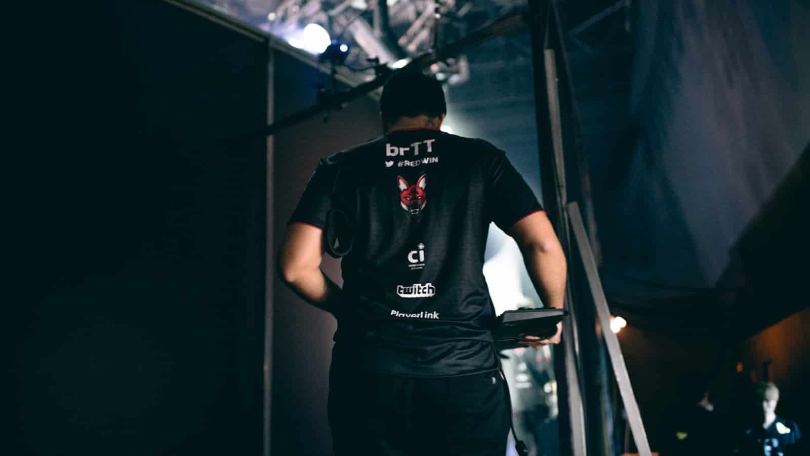 paiN Gaming's Felipe “brTT” Gonçalves walks away from the camera with his jersey sporting his name is visible.