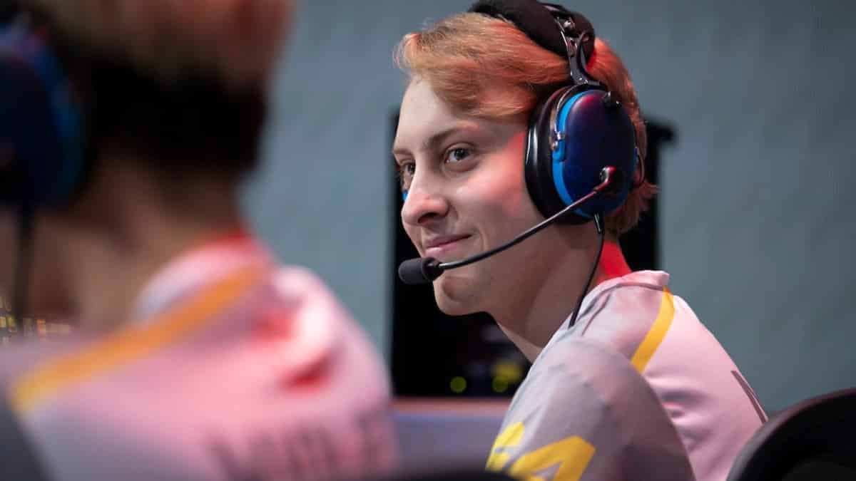 Pro Overwatch player Grant "moth" Espe smiles at a teammate to his side on the OWL stage.