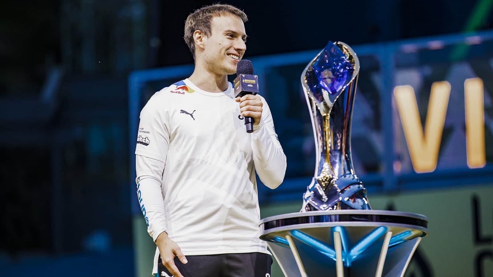 Cloud9 mid laner Luka "Perkz" Perković talks into a mic during an interview with the LCS trophy behind him.