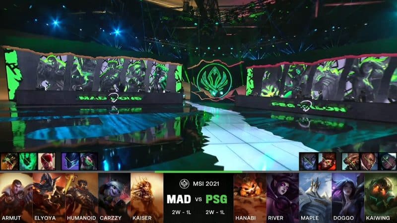 A screenshot from the LoL Esports broadcast for the Mid-Season Invitational (MSI) match between MAD Lions and PSG.Talon. The picked and banned champion drafts appear at the bottom of the image with a shot of the 2021 MSI stage above.