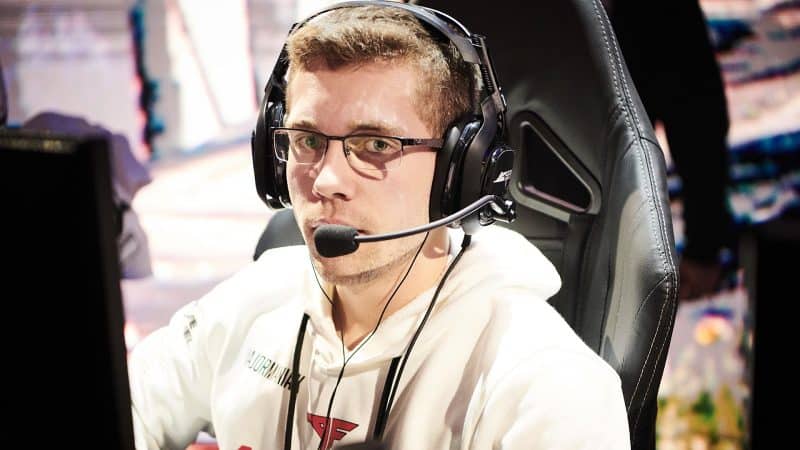 Michael "MajorManiak" Szymaniak looks at the camera with a headset on on stage.